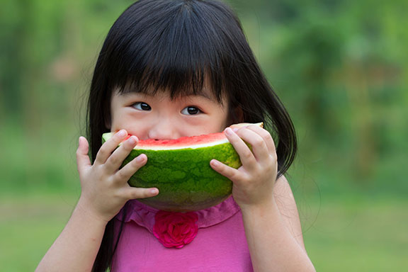 young Asian child eating healthy food 