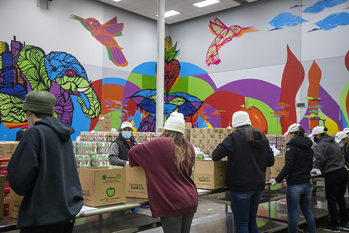 The mural in our repack room where volunteers pack and create boxes and bags of food was created by Daniel Anguilu in Fall 2019.
