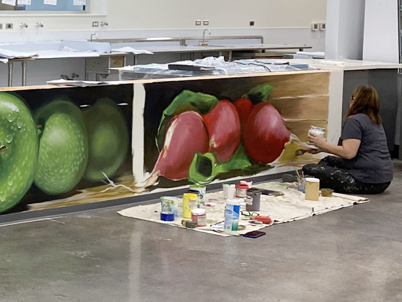 Paintings of extremely realistic produce by artist Anant Ronen greet patrons of the newly renovated Houston Texans Cafe