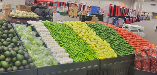 Rows of colorful produce sit neatly in a stand at a local area food show.