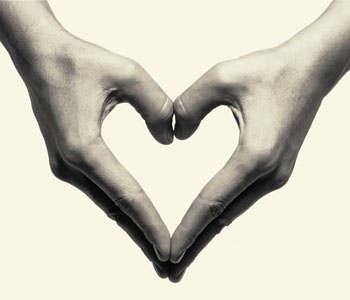 Two hands come together to create the shape of a heart.