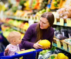 Woman produce shopping with her child.