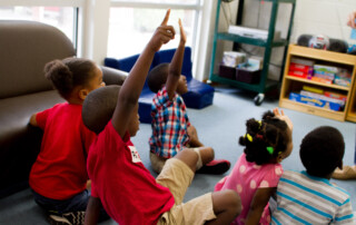 Group of children raising hands