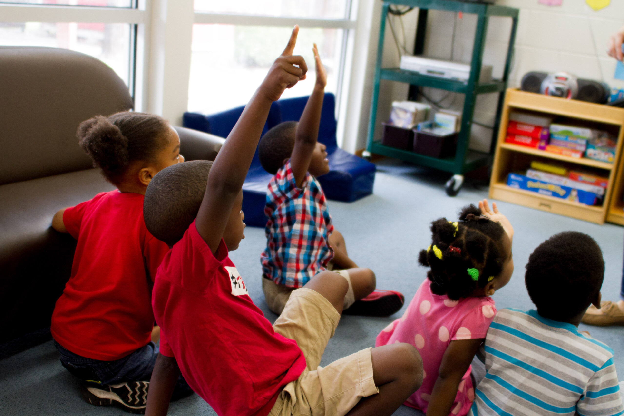 Group of children raising hands