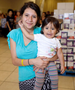 A mother holding her daughter.