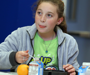 Young girl eating food.