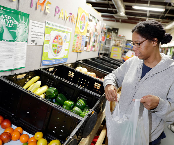 A woman shops for produce at a food pantry.