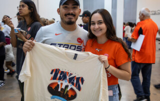 713 Day volunteers holding up the 2025 shirt.