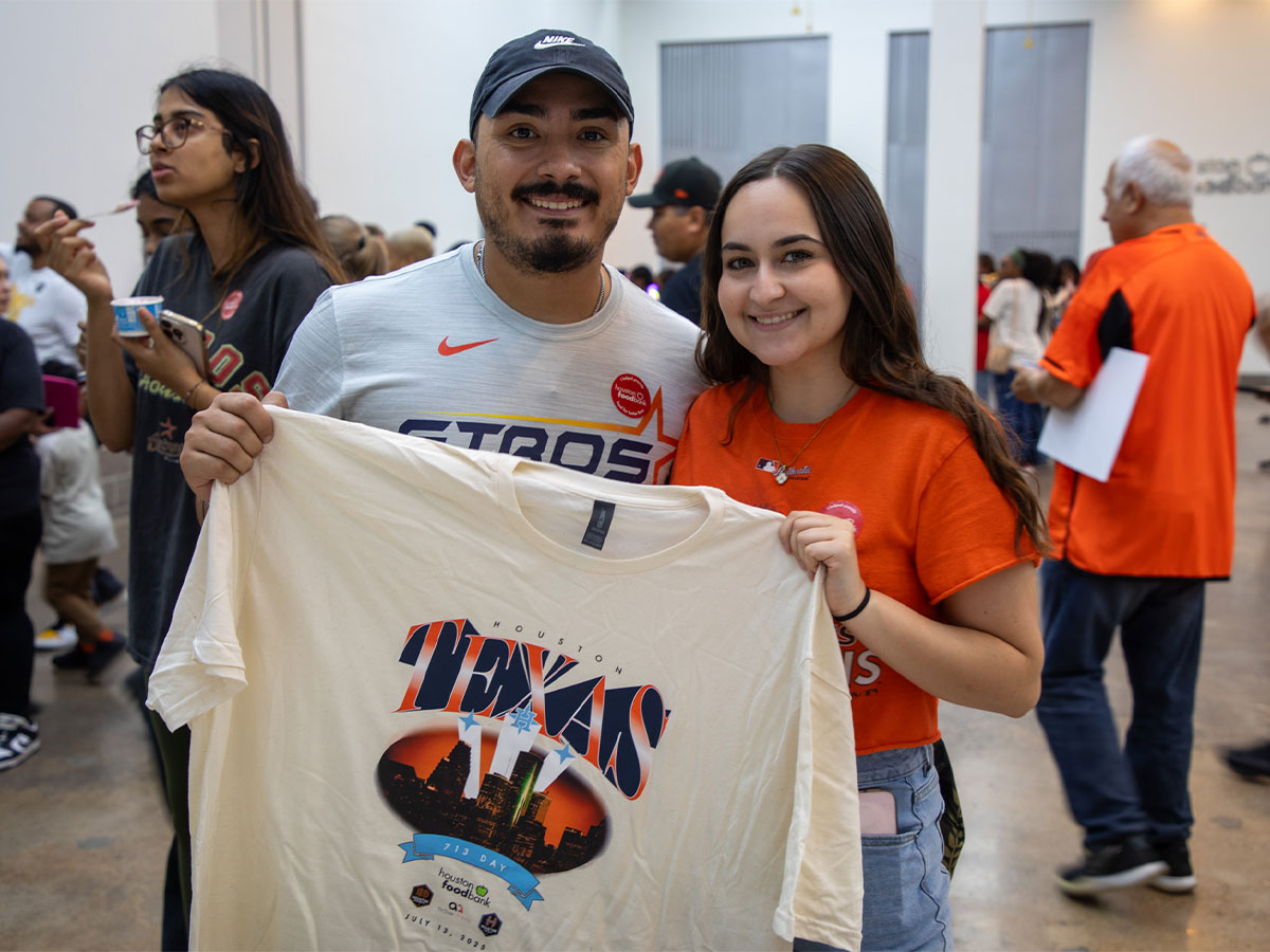 713 Day volunteers holding up the 2025 shirt.