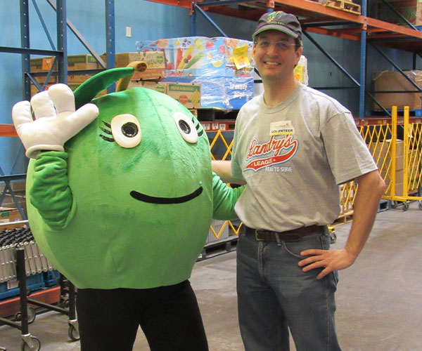 Corey and a Volunteer in the Houston Food Bank warehouse.