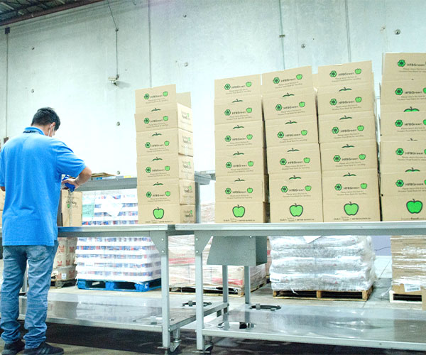 A volunteer packs disaster boxes at Houston Food Bank north branch