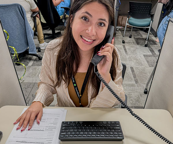 A Houston Food Bank volunteer works a phone bank.