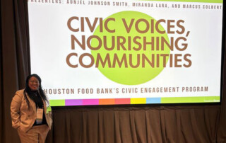 Aunjel Johnson Smith stands by the Civic Voices, Nourishing Communities display.