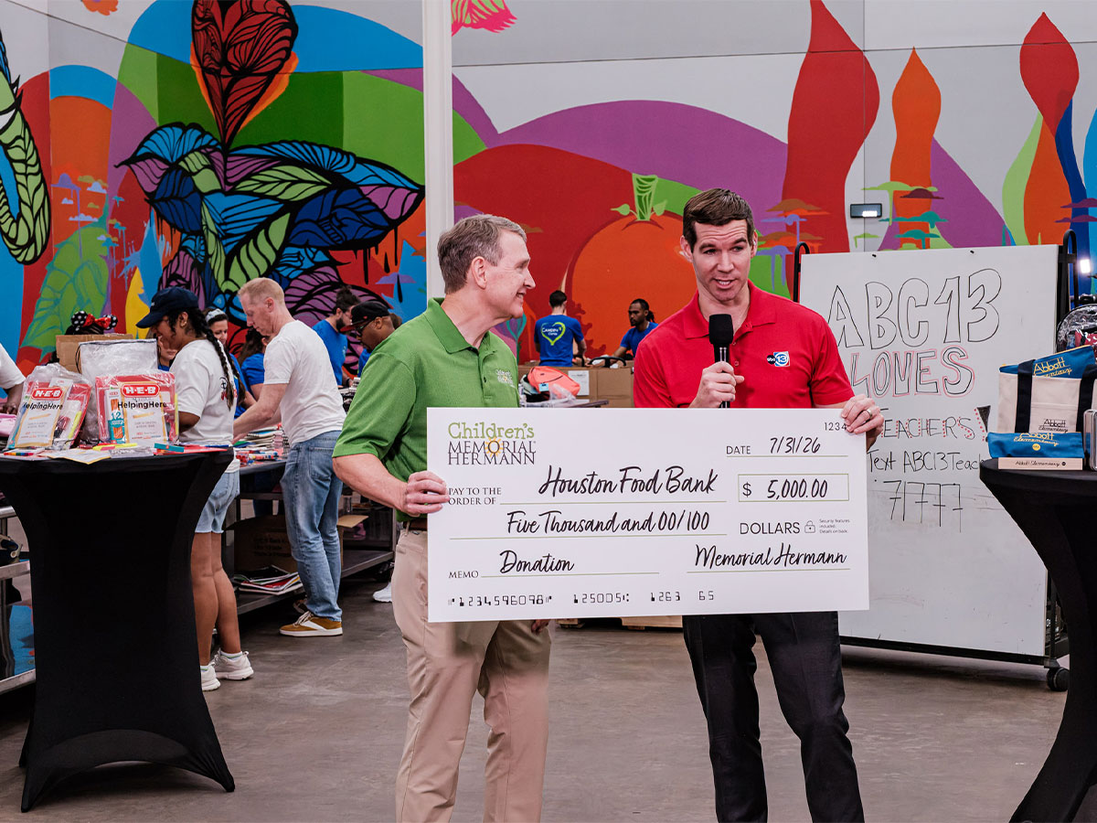 ABC13 LovesTeachers 2026 1200×900 Children's Memorial Herman presents a $5000 check at the ABC13 Loves Teachers event.