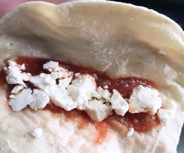 CornTortillas 600×500 A corn tortilla with cheese and salsa.